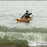 Bryan Hansel testing out the new stern shape in the cold Lake Superior spring. Snow still on the rocks and one foot waves to paddle in.