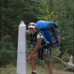 hansel_bryan_100901-693 Ilena on monument portage at a monument marking the border of the U.S. and Canada.