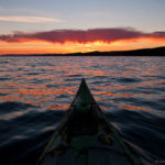 A kayak and an expanse of Lake Superior at sunset.