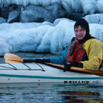 Kayaker paddling on Lake Superior in winter.