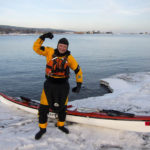 A paddler dressed with the right gear for kayaking in winter.