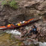 Rock beach and kayaks on Lake Superior.