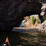 Kayaking through a sea arch on Lake Superior at the Manitou River
