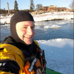 Kayaker sitting on ice cake.