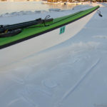 Kayak and 12 months etched out of snow.