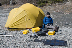 Using a computer on a remote beach during an expedition