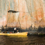 canoeing past pictographs in the wilderness