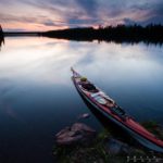 A kayak on the shore of Cascade Lake at sunset.