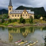 Kayaks on the beach at the Vågan Church.