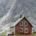 The shape of this simple house seems to flow directly from the cliff face in the background.